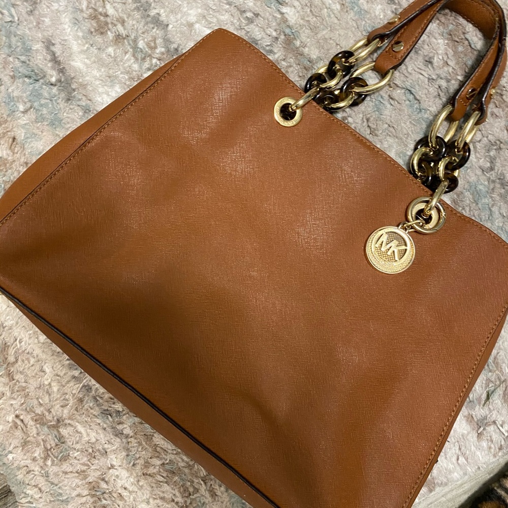 Brown Michael Kohrs purse.